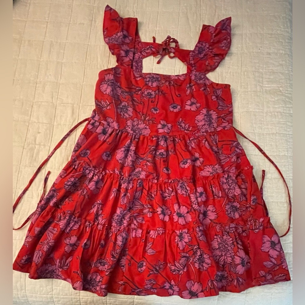 Mid-thigh length red dress with purple flowers. Ties in the back.